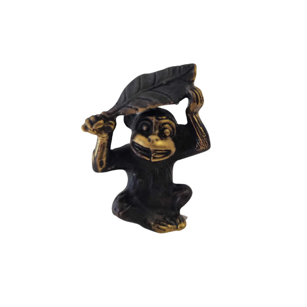  Antique brass monkey with leaf overhead